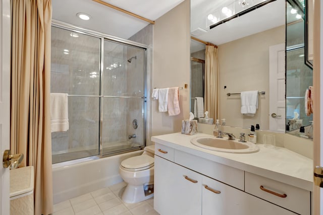 full bathroom featuring tile patterned floors, enclosed tub / shower combo, vanity, and toilet