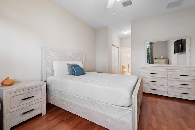 bedroom featuring ensuite bathroom, dark wood-type flooring, ceiling fan, and a closet