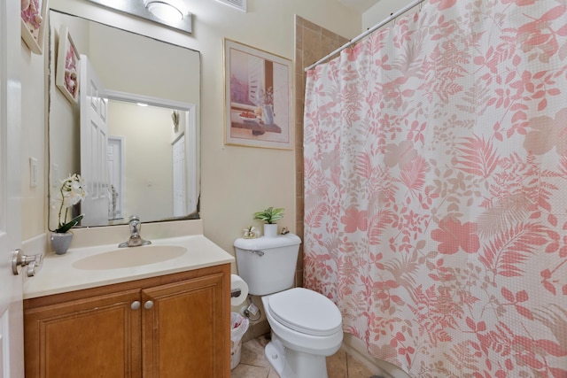 bathroom with toilet, vanity, tile patterned flooring, and curtained shower