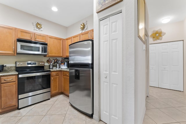 kitchen with stainless steel appliances and light tile patterned floors