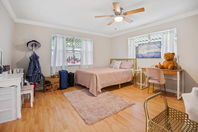 bedroom with ornamental molding, ceiling fan, and light wood-type flooring