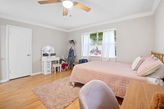 bedroom with hardwood / wood-style flooring, ornamental molding, and ceiling fan