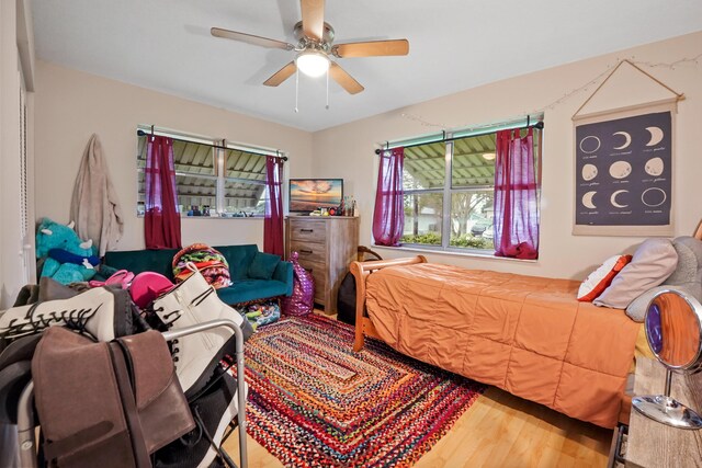 bedroom featuring hardwood / wood-style flooring, crown molding, and ceiling fan