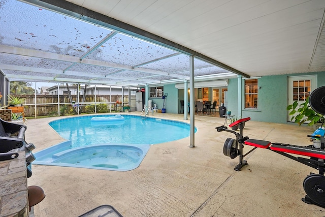 view of swimming pool with a lanai, a patio, and a hot tub