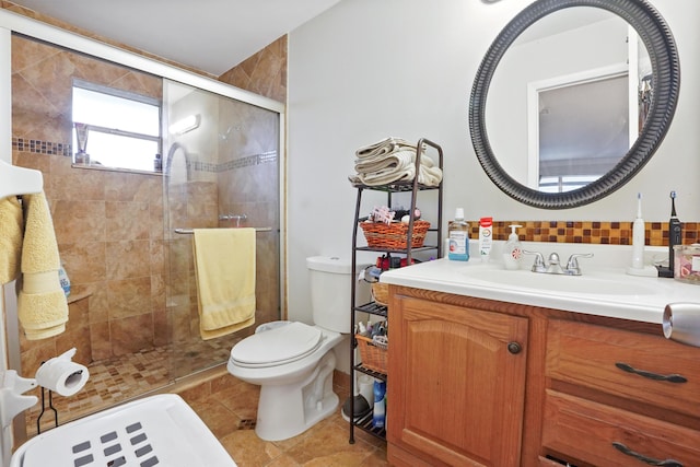 bathroom with vanity, backsplash, toilet, and walk in shower