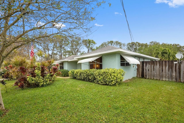 view of home's exterior with a lawn