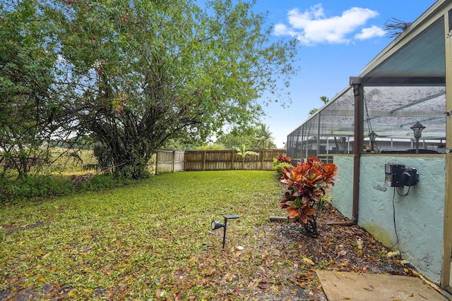 view of yard with glass enclosure