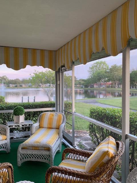 sunroom / solarium featuring a water view