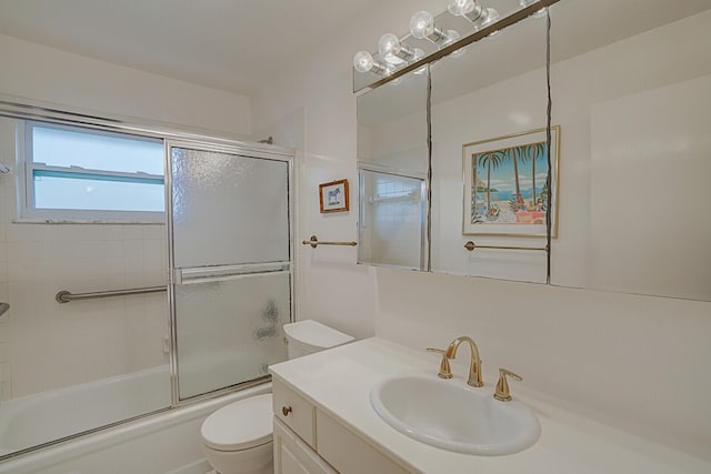 full bathroom featuring enclosed tub / shower combo, vanity, and toilet