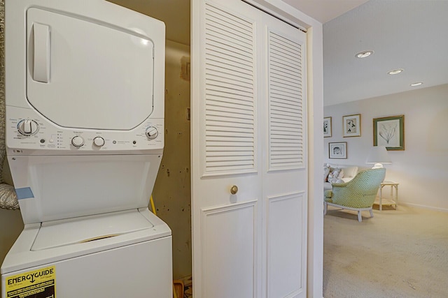 washroom with carpet and stacked washer and dryer