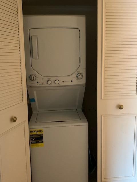 clothes washing area with stacked washer and dryer