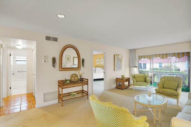 living room with a healthy amount of sunlight and light colored carpet