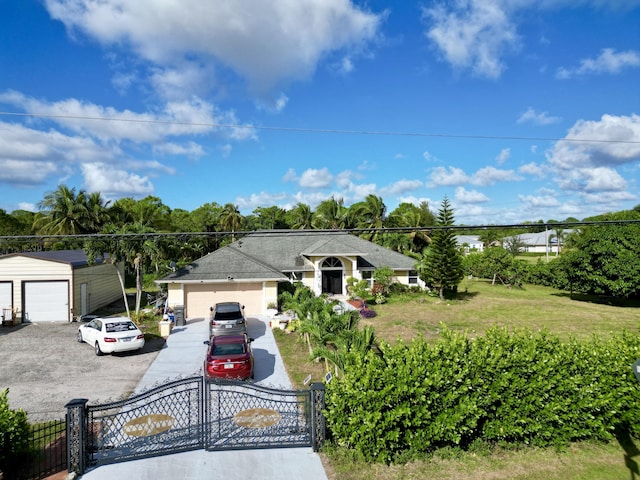 view of front of house featuring a front lawn and a garage