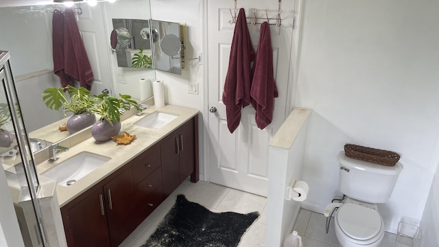 bathroom featuring toilet, tile patterned floors, and vanity