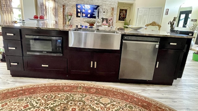 kitchen featuring appliances with stainless steel finishes, light hardwood / wood-style floors, and sink