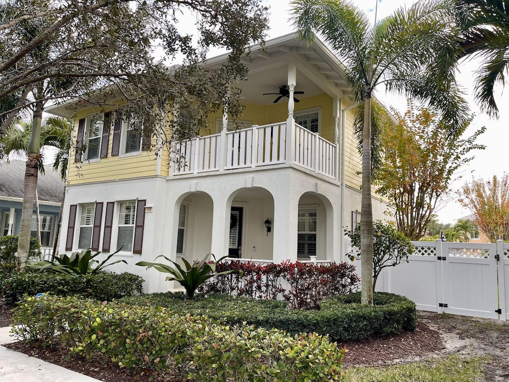 view of front of property with a balcony and ceiling fan