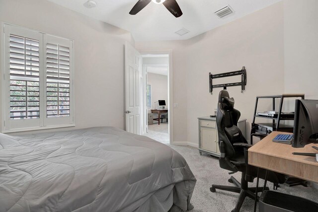 bedroom with light carpet and ceiling fan