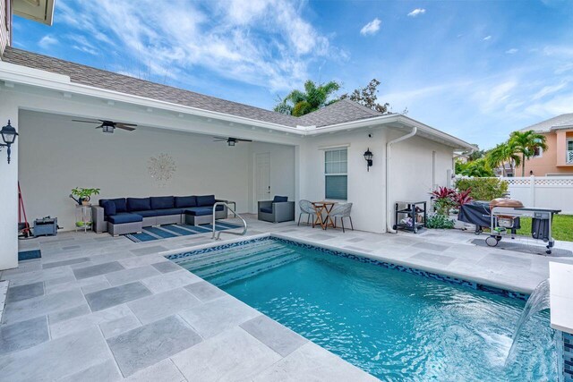 view of pool featuring ceiling fan, outdoor lounge area, a patio area, grilling area, and pool water feature