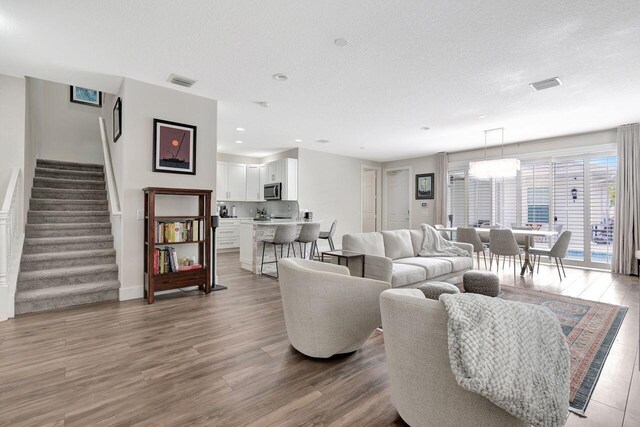 living room featuring hardwood / wood-style flooring and a textured ceiling