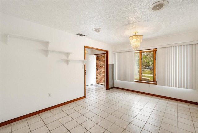 unfurnished room with a notable chandelier