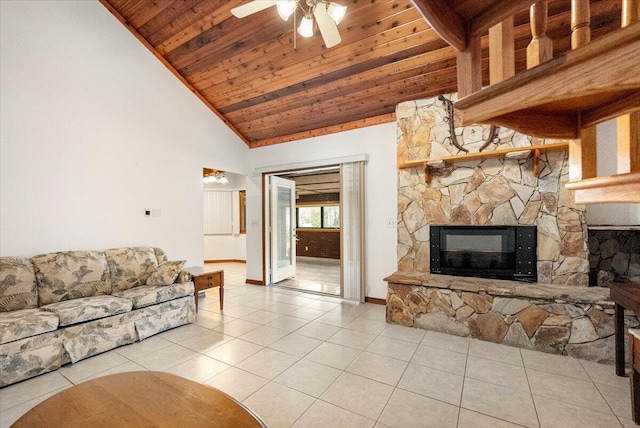 living room with wood ceiling, a stone fireplace, light tile patterned floors, ceiling fan, and high vaulted ceiling