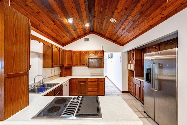 kitchen featuring sink, dishwasher, light tile patterned flooring, stainless steel fridge, and stovetop