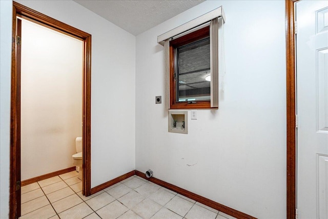 washroom featuring a textured ceiling, hookup for a washing machine, and hookup for an electric dryer