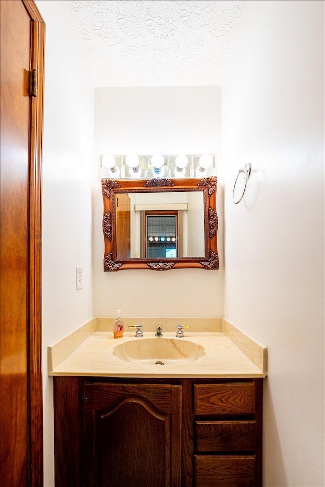 bathroom featuring vanity and a textured ceiling