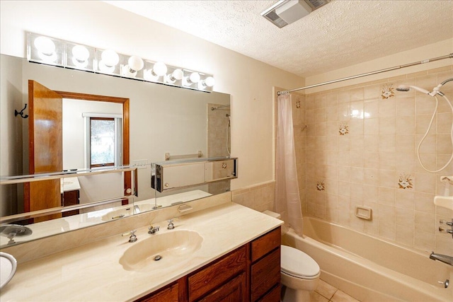 full bathroom with a textured ceiling, shower / tub combo, toilet, tile patterned floors, and vanity