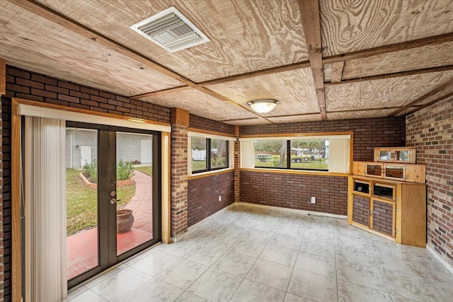 tiled empty room with brick wall