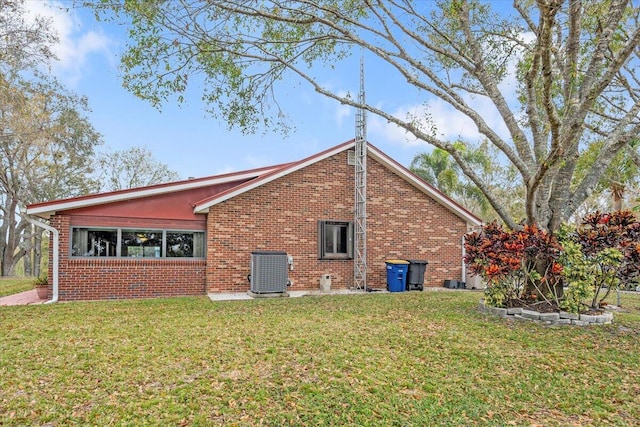 view of home's exterior with central AC and a lawn