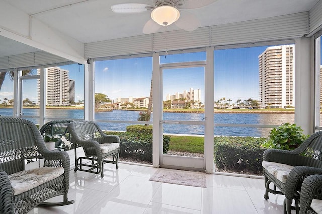 sunroom / solarium featuring a healthy amount of sunlight and a water view