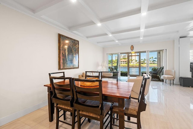 dining area with coffered ceiling, light tile patterned floors, beamed ceiling, and a water view