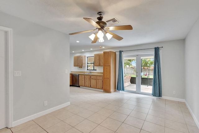 unfurnished living room with ceiling fan, light tile patterned floors, french doors, and sink