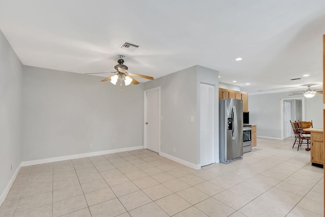 kitchen with ceiling fan, light tile patterned floors, and stainless steel appliances