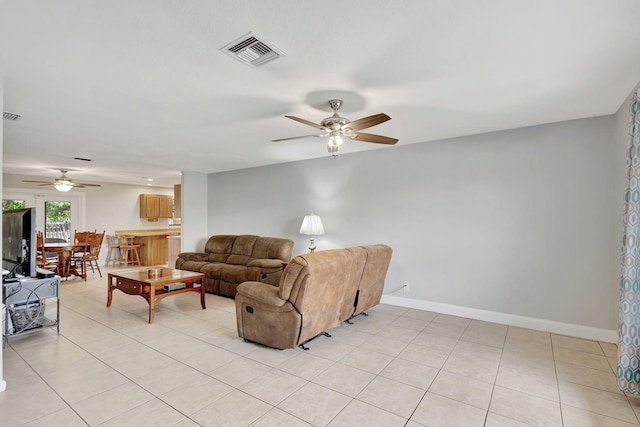 living room with ceiling fan and light tile patterned floors