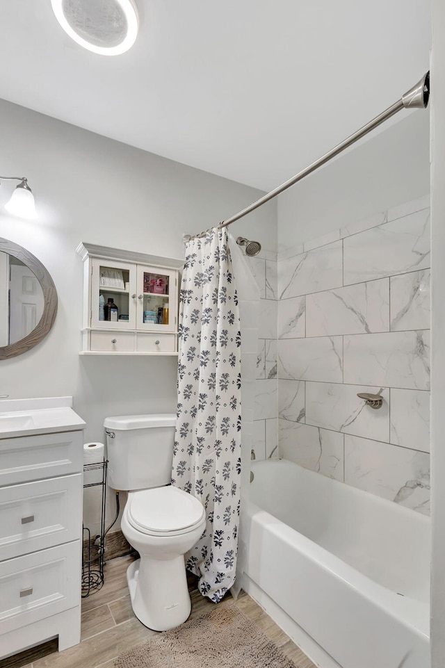 full bathroom with toilet, vanity, and shower / bath combo with shower curtain