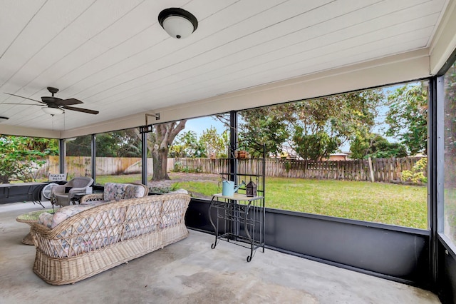 sunroom / solarium featuring ceiling fan