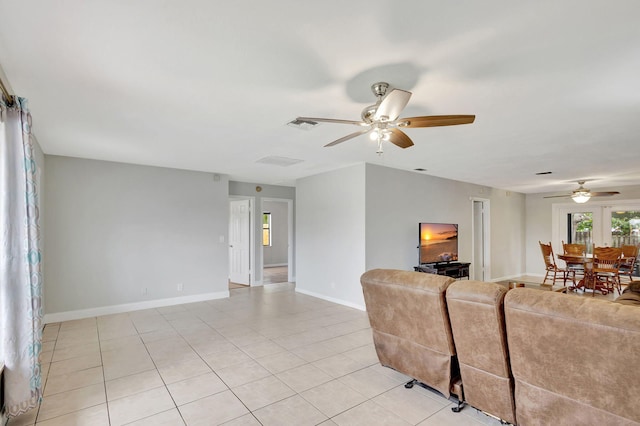 living room with ceiling fan and light tile patterned floors