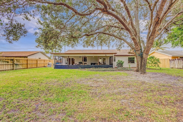 rear view of house featuring a lawn