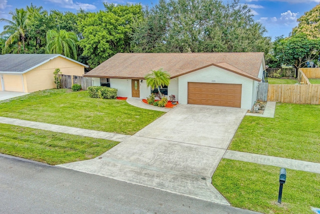 ranch-style house featuring a front lawn and a garage