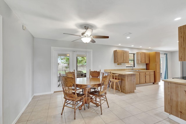 tiled dining area with ceiling fan, french doors, and sink