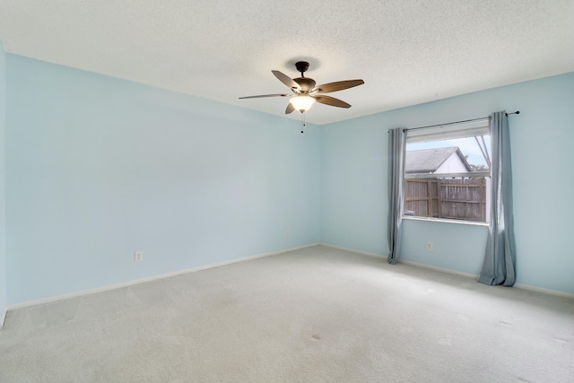 carpeted empty room featuring a textured ceiling and ceiling fan