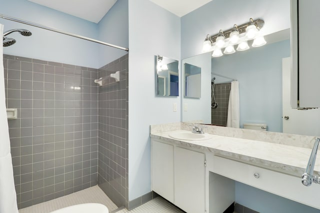 bathroom featuring tile patterned flooring, curtained shower, vanity, and toilet