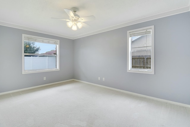 carpeted empty room featuring ceiling fan and crown molding