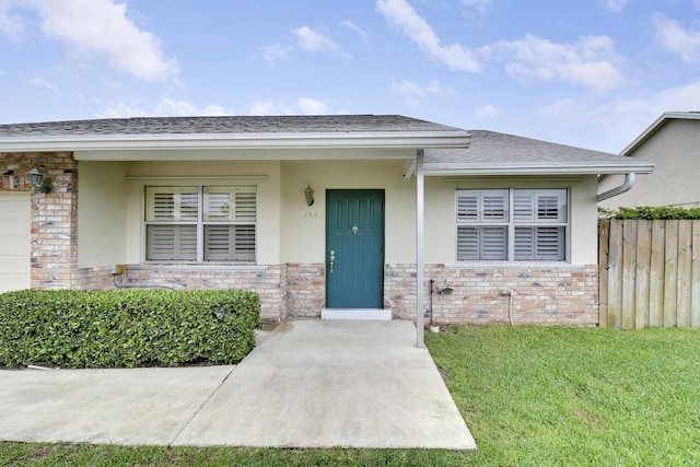 entrance to property with a lawn