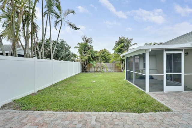 view of yard featuring a sunroom