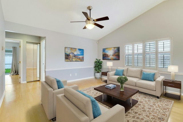 living room with lofted ceiling, ceiling fan, and light hardwood / wood-style flooring