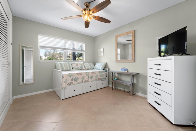 tiled bedroom featuring ceiling fan