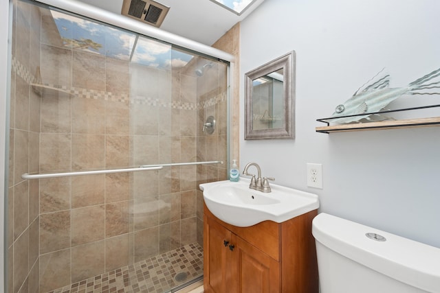 bathroom featuring vanity, toilet, and walk in shower